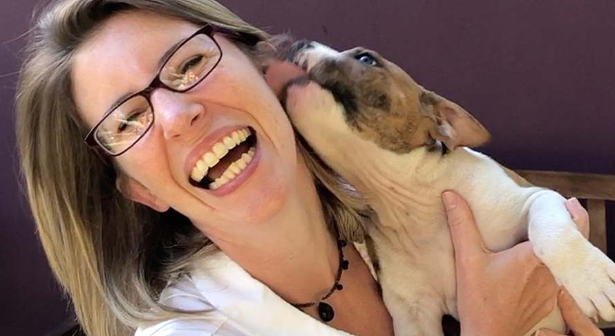 Image of woman being licked by her dog