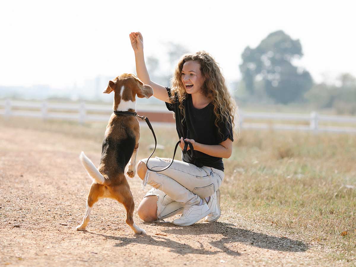 Image of woman playing with dog